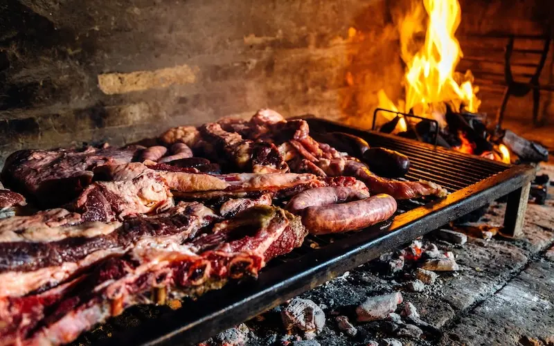 Traditional Uruguayan asado barbecue with grilled meats on a parrilla